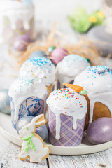 Easter table with Easter cakes and Easter eggs over white background