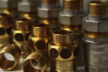 Rows of plumbing valves and nuts. Closeup.