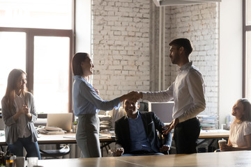 Company ceo handshaking with employee woman express regard and gratitude