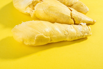Fresh delicious durian flesh on yellow background