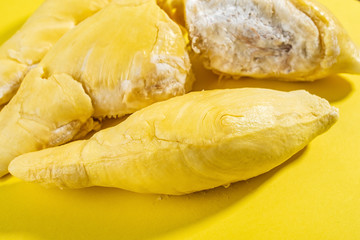 Fresh delicious durian flesh on yellow background