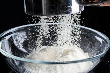 Naklejka na ściany i meble Pour the flour in a transparent bowl for making dough, freezing