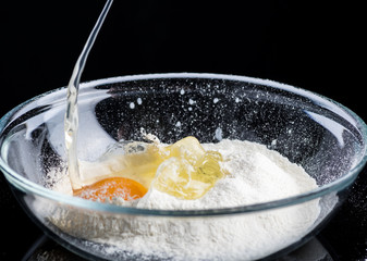 Add eggs and flour to a transparent bowl for making batter.