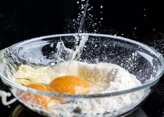 Add eggs and flour to a transparent bowl for making batter.