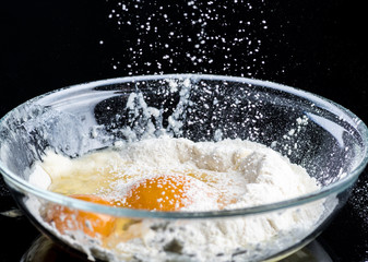 Add eggs and flour to a transparent bowl for making batter.