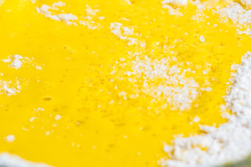 Add eggs and flour to a transparent bowl for making batter.
