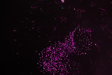 Beautiful scattering of bright purple sparkling firework lights during Halloween, Christmas,...