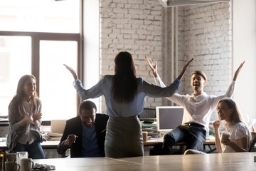 Happy diverse employees celebrating successful accomplishment of project