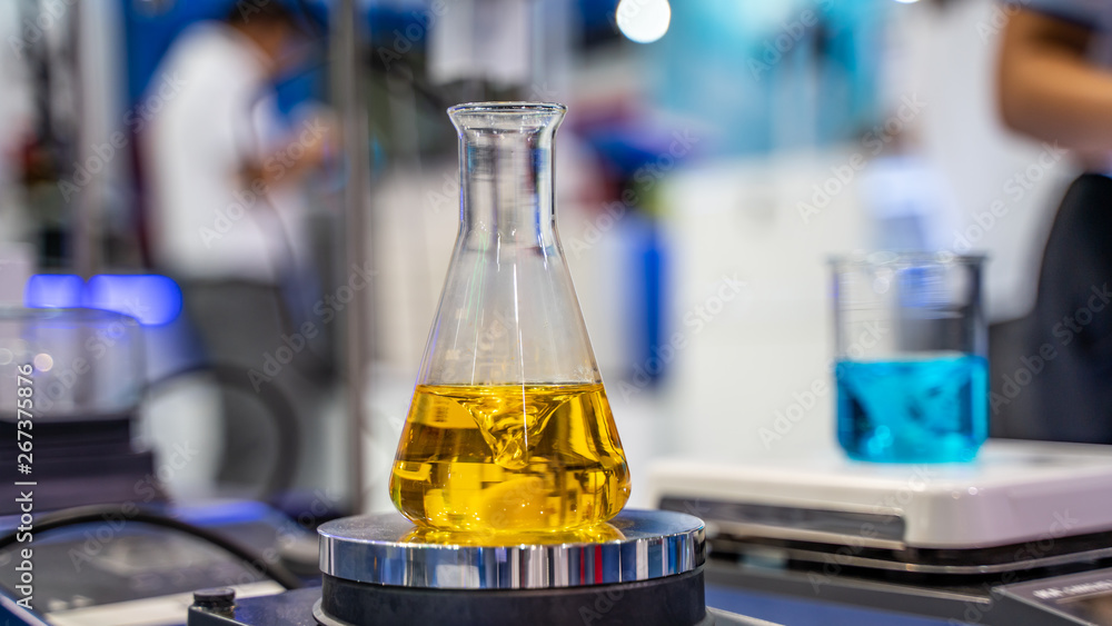 Poster testing blue liquid solution in glass flask in science laboratory