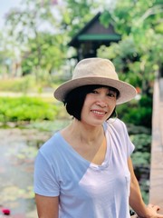 People, beauty, fashion, vacation or happy life concept : Outdoors close up portrait of girl smiling or Asian woman smiling in the park and looking at camera