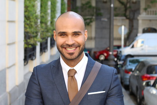Elegant bald man smiling outdoors 