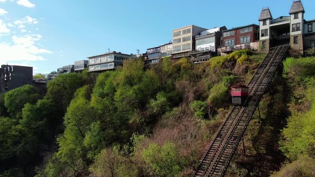 Aerial view of Duquesne Incline and Mount Washington in Pittsburgh, Pennsylvania, drone follows funicular railway car on the way to the top station