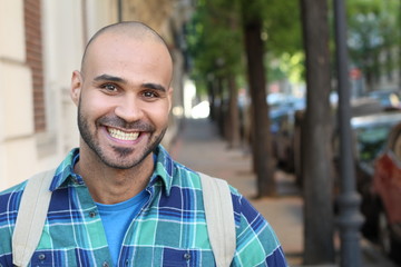 Handsome young ethnic man smiling with copy space 