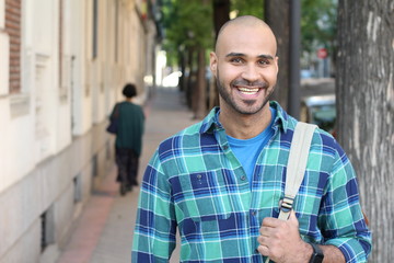 Real looking ethnic man smiling outdoors 