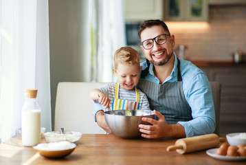 happy family in kitchen. father and child baking cookies  .