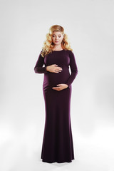 Beautiful pregnant woman in dark dress. studio shot