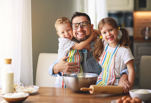 father with children   baking cookies. - Powered by Adobe
