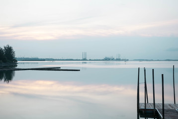 Beach landscape view with wooden foot bridge during sunset. Beatiful screnery of a beach with ocean and sky and water reflection