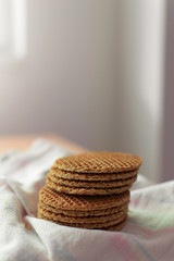 Fresh stroopwafels with caramel on white cloth.