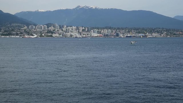 A seaplane is touching down to the sea. Burrard Inlet Vancouver BC Canada   2