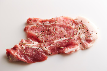 Fresh raw seasoned pork on white background 