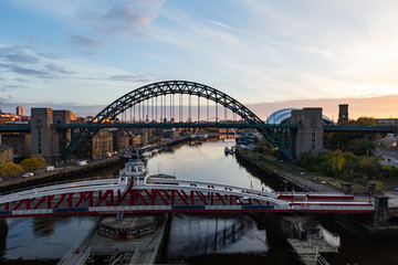 The Tyne Bridge in Newcastle Upon Tyne showing its full magnificent span as the sun rises in the background