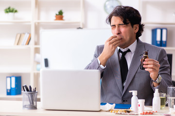 Man with flu working in the office