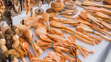 Handmade wooden spoons at souvenir market at festival