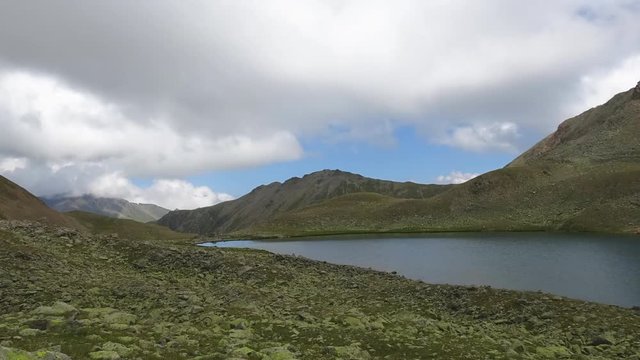 Timelapse lake scene in mountains, national park of Dombay, Caucasus, Russia. Summer landscape, sunshine weather, blue sky and sunny day