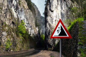 Falling rocks warning sign on mountain road