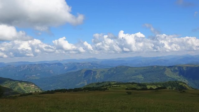 Time lapse mountains scene in national park of Dombay, Caucasus, Russia, Europe. Summer landscape, sunshine weather, blue sky and sunny day