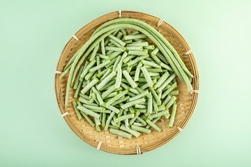 Fresh vegetables kidney beans on a light green background