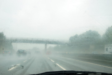 Bad weather through front window of moving car  - 267382491