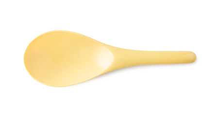 Yellow plastic spoon or ladle isolated on white background.