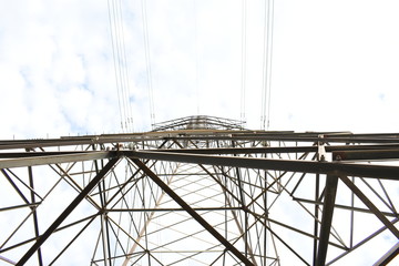 metal tower and cables towards the sky