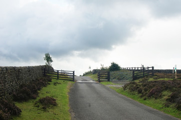 Rural country road with wooden gate in Yorkshire - 267383080