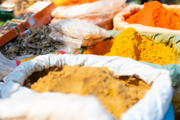 Colorful curry a pepper spices powders and herbs in traditional street spice market in Varanasi, India