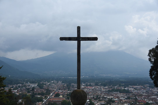 RELIGIOUS CROSS ON MOUNTAIN AGAINST SKY