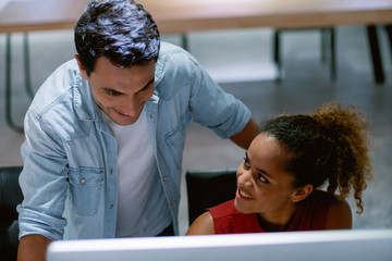 Working woman and man sharing idea about their work in co working place