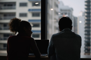 Working woman and man sharing idea about their work in co working place