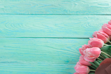 Fototapeta na wymiar Floral background. Pink tulips on vintage blue background with copy space. Post card, gift card template. Wedding, birthday, spring and summer concept