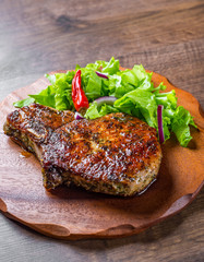 Pork Loin chops marinated meat Steak with vegetables slad on wooden table background