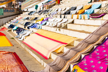 Varanasi, India, Mar 10 2019 - People washing clothes on the ghats of Varanasi near Sacred Ganga...
