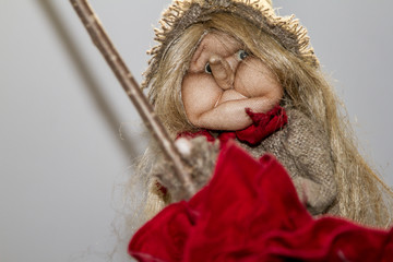 The old woman witch flies on a broomstick. Sorceress from old Russian fairy tales. Witch in beautiful clothes and a hat. Baba Yaga is a hasty old woman who owns magical objects and endowed with magica