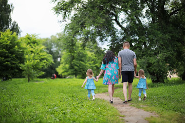 Fototapeta premium Mom with two daughters twins