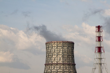 Thermal power station. Smoke from the pipes. Sunny day, blue sky background.