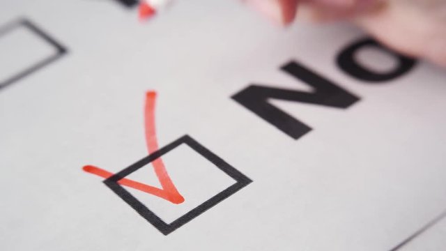 Marking checkbox with no. Red pen or marker. Elections or voting.