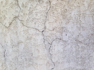 vintage concrete wall with cracks, painted white, background stock texture