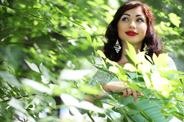 Fototapeta premium Beautiful girl in a spring leaf park