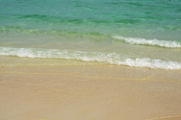 beautiful the beach closeup smooth sand and blue sea water. vacation background on summer in Thailand.